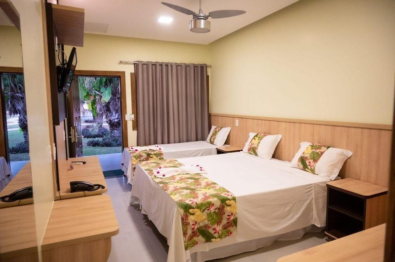 Standard room with two beds and a door that opens to the garden