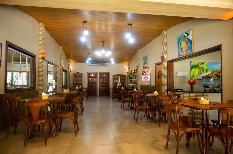 The dining room of Pousada Piuval, with wooden tables and chairs